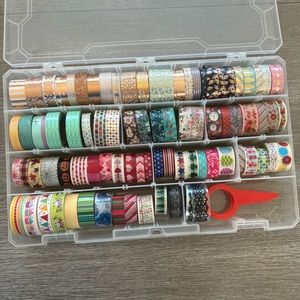 Large bundle of washi tape with storage container and tape cutter